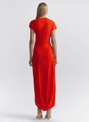 Woman wearing a red-orange dress on a white background