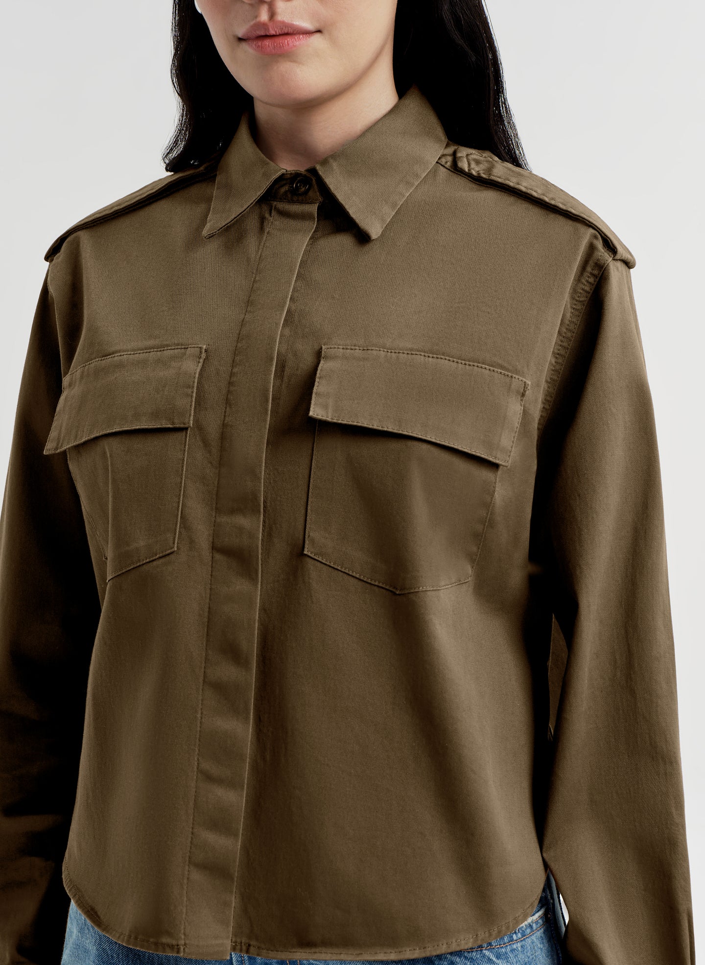 Brown jacket worn by a person on a white background