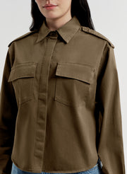 Brown jacket worn by a person on a white background