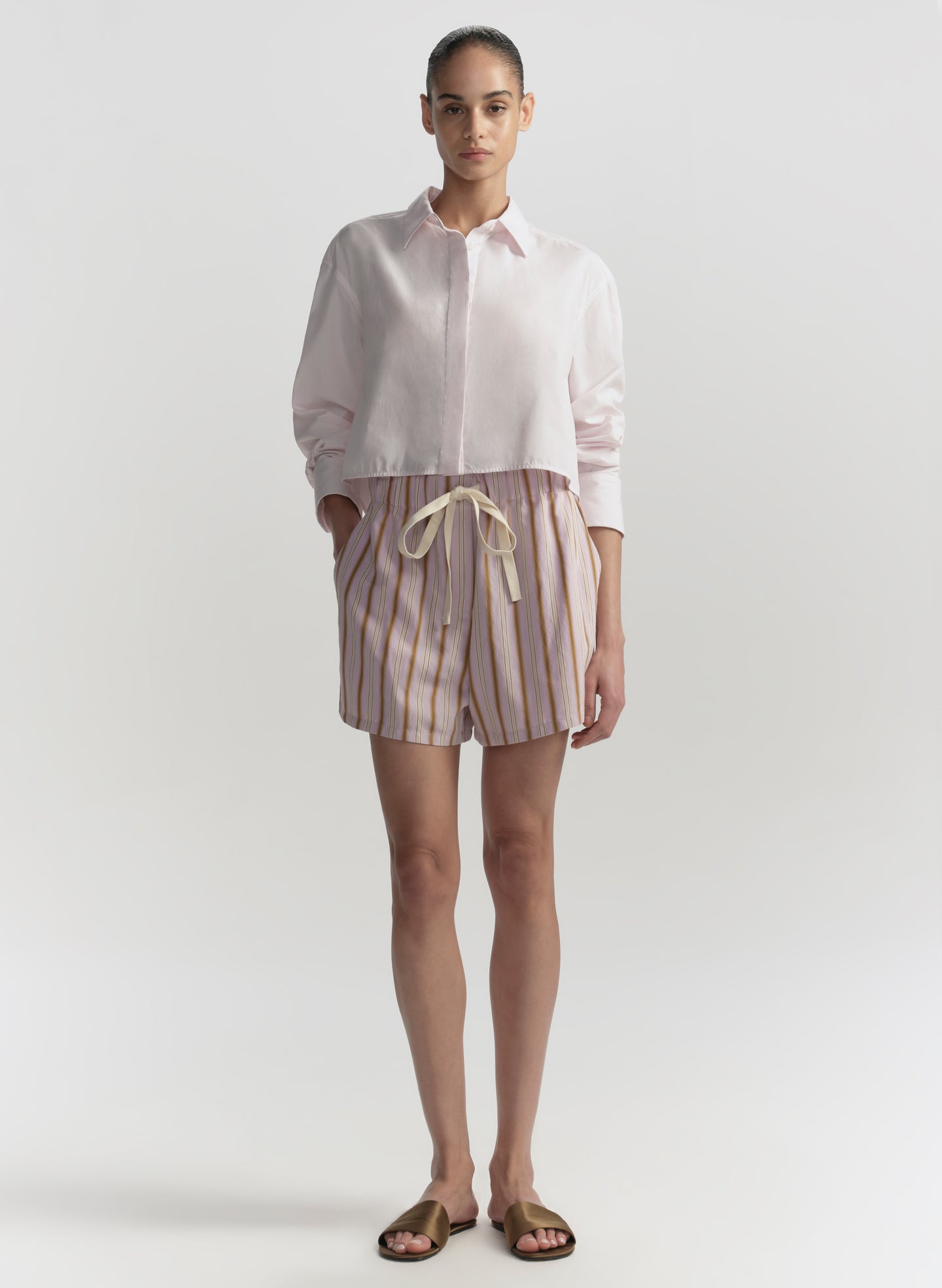 woman wearing pink shirt and striped shorts