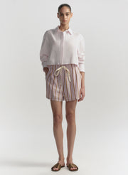 woman wearing pink shirt and striped shorts