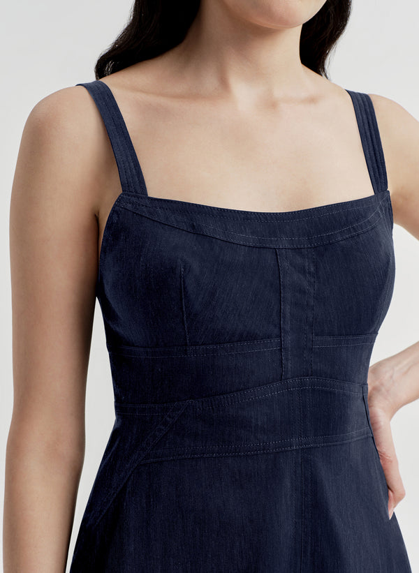 Navy blue dress worn by a person on a white background