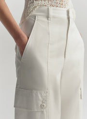 Light-colored pants worn by a person on a plain background