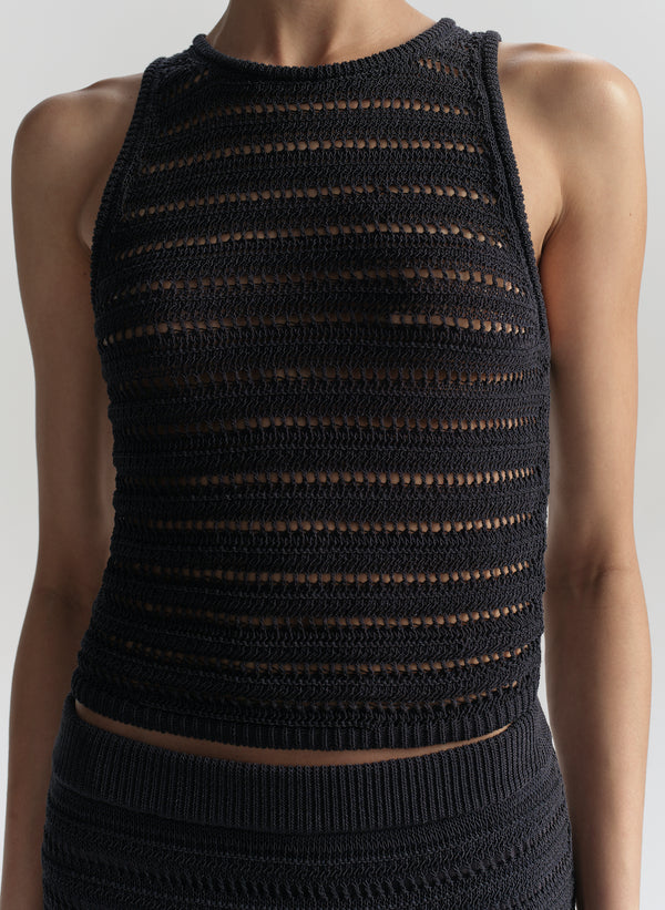 Blue knitted sleeveless top against a white background