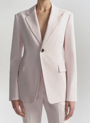 Light pink suit jacket and pants on a white background