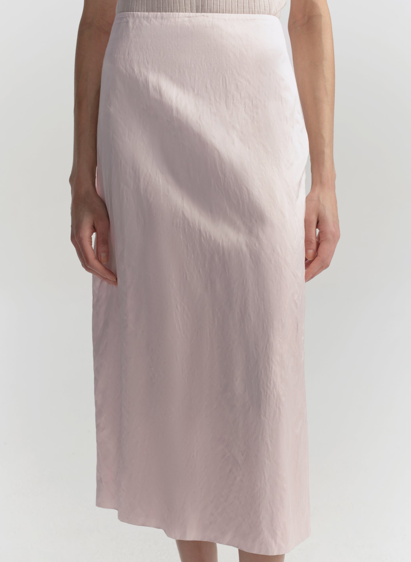 Light pink skirt worn by a person on a white background