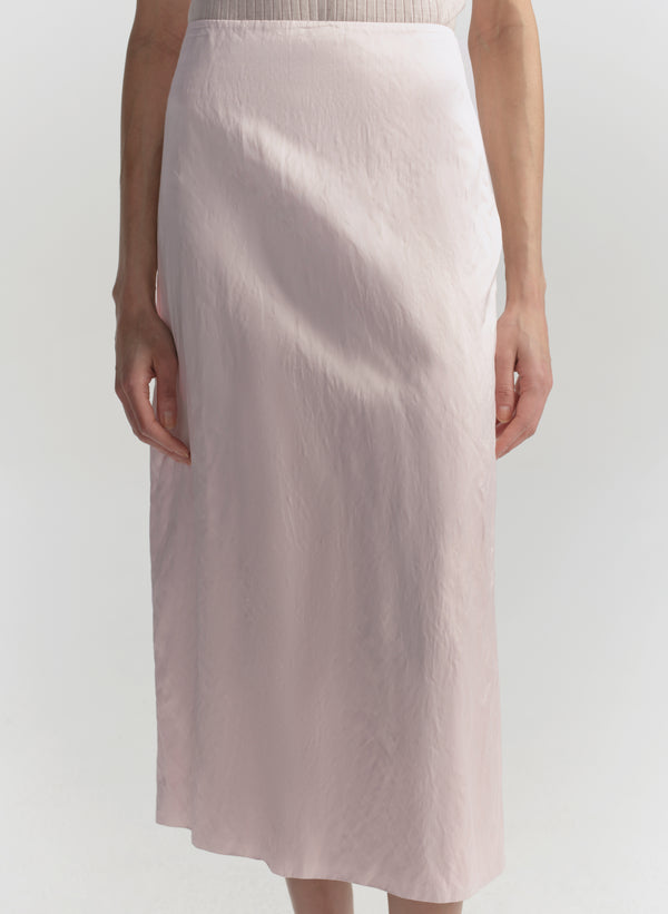 Light pink skirt worn by a person on a white background