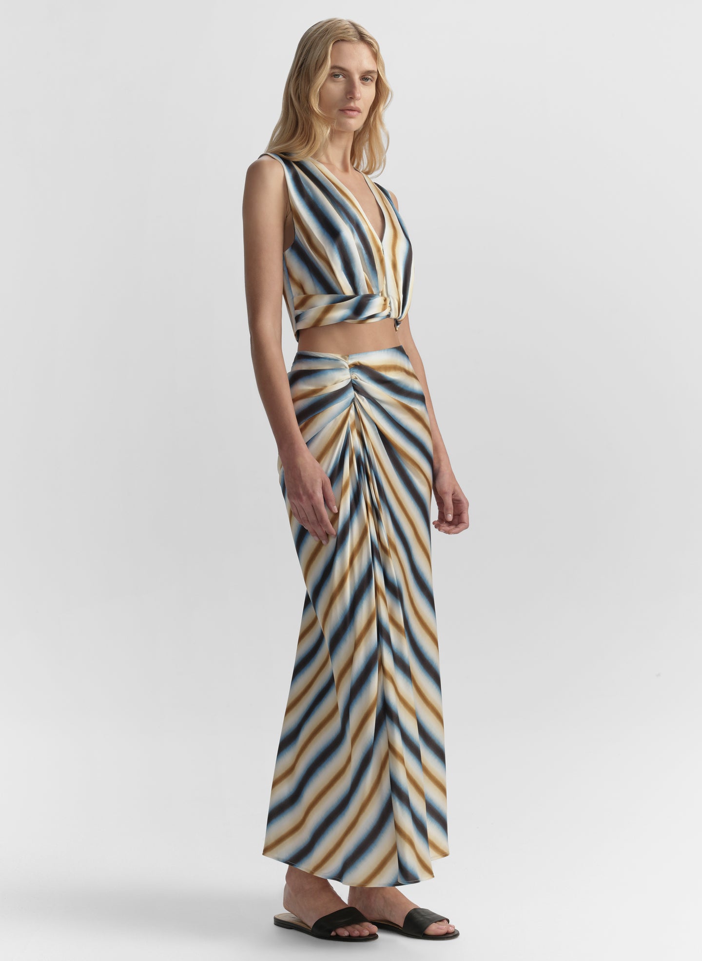 Woman wearing a striped top and skirt on a white background