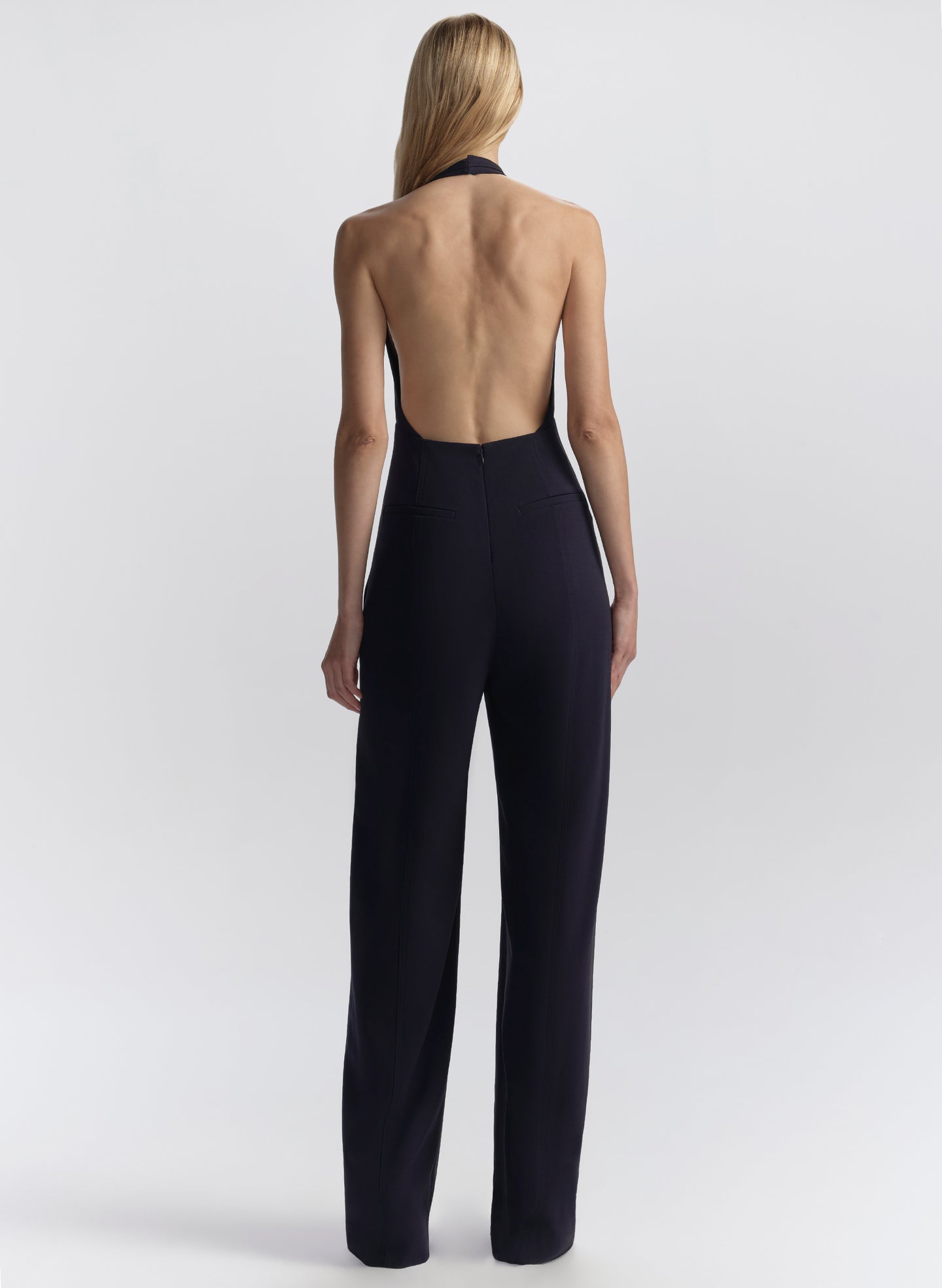 woman wearing navy blue halter jumpsuit