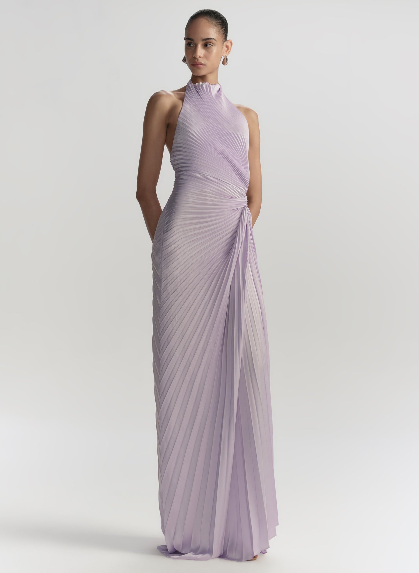 Woman wearing a lavender evening gown on a white background