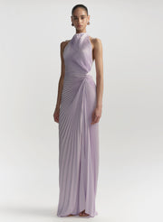 Woman wearing a long, light purple dress on a white background