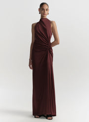 Woman wearing a burgundy evening gown on a white background