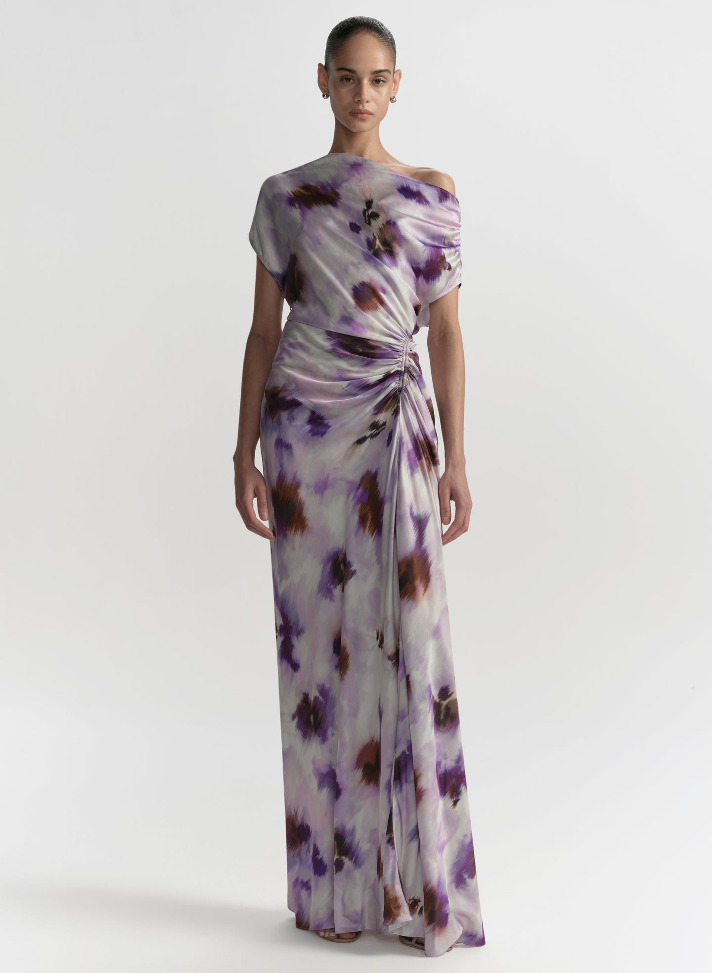 Woman wearing a floral-patterned dress on a white background