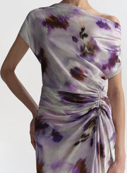 Purple and white floral one-shoulder dress on a plain background