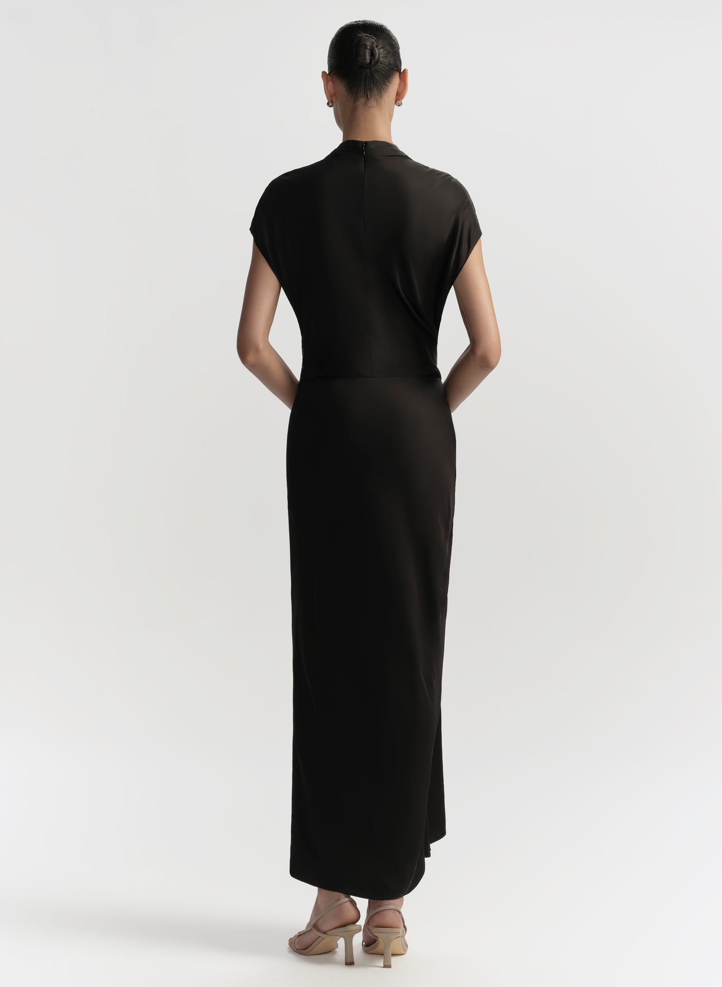 Woman wearing a black dress on a white background