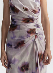 Woman wearing a sleeveless dress with abstract pattern on a white background