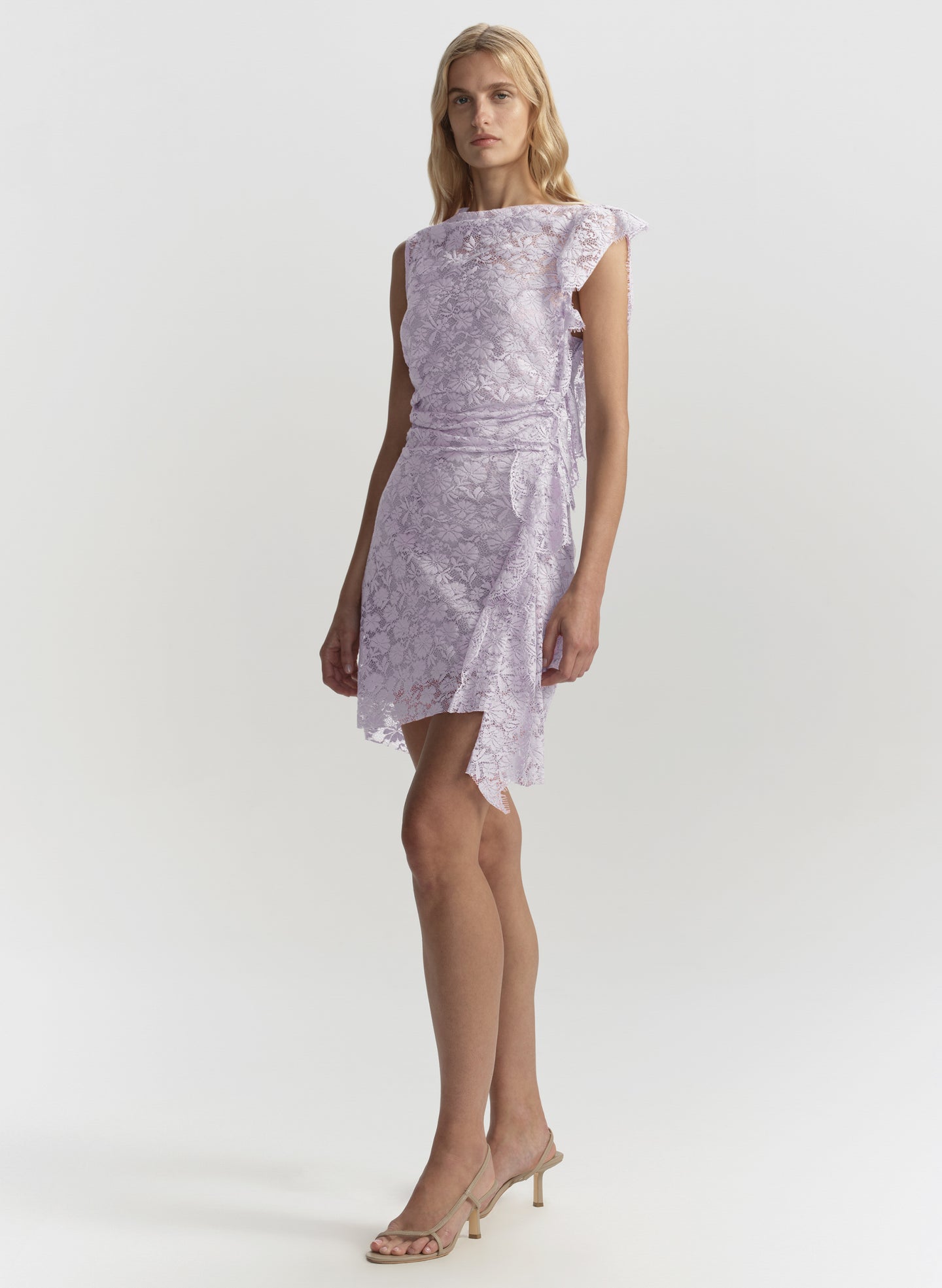 Woman wearing a light purple floral dress on a white background