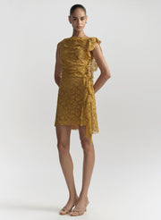 Woman wearing a mustard yellow dress on a white background