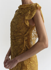 Yellow lace dress with ruffled shoulders on a white background