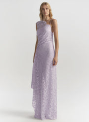 Woman wearing a lavender lace dress on a white background