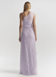 Woman wearing a long, light purple lace dress on a white background