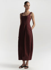 Woman wearing a burgundy dress on a white background