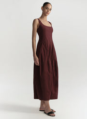 Woman wearing a burgundy dress on a white background