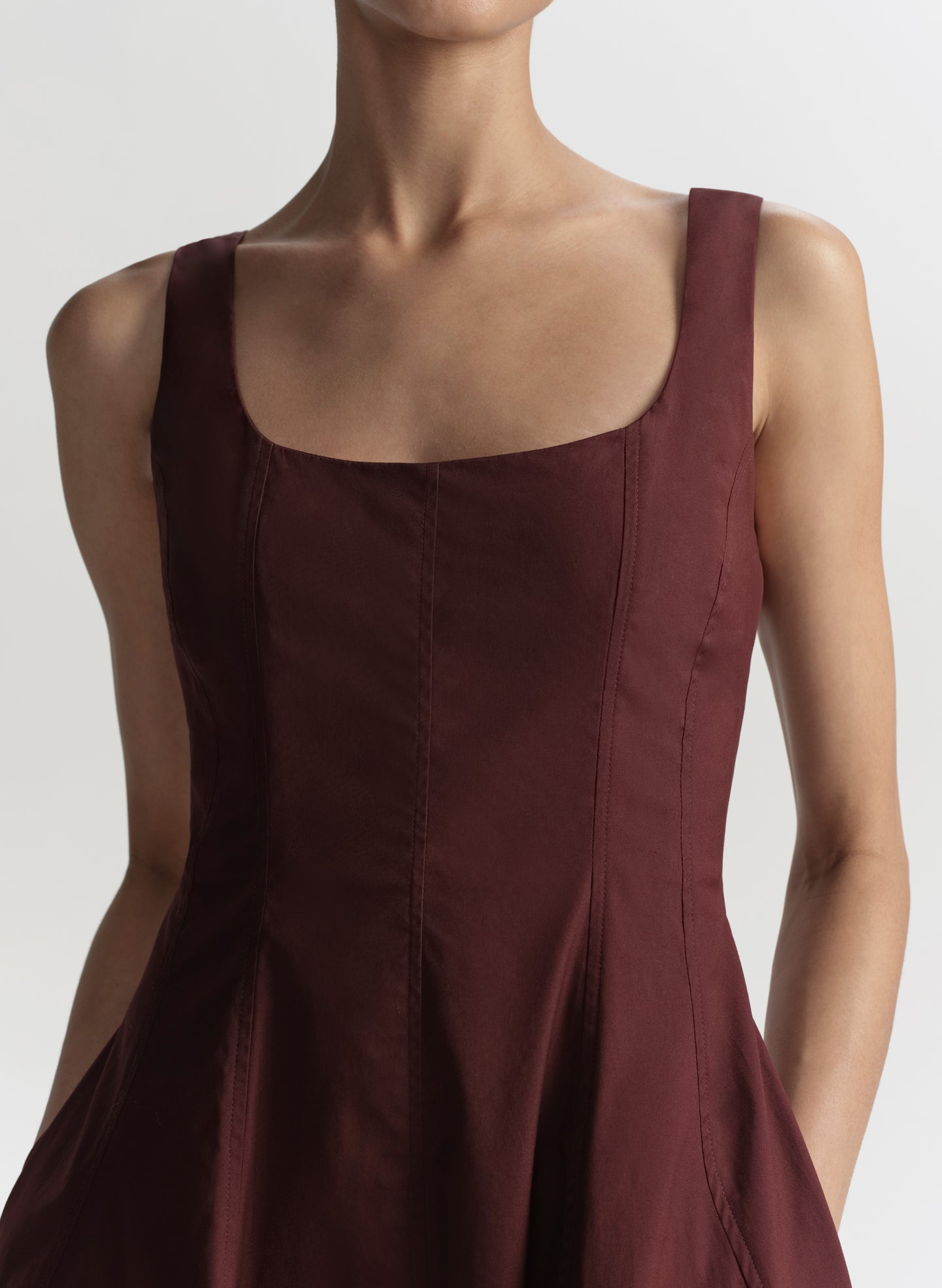 Brown dress worn by a model on a plain background