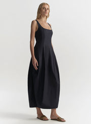 Woman wearing a blue sleeveless dress on a white background