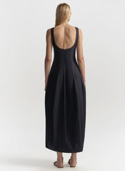 Blue sleeveless dress with open back worn by a model on a white background