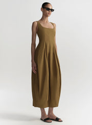 Woman wearing a long brown dress on a white background