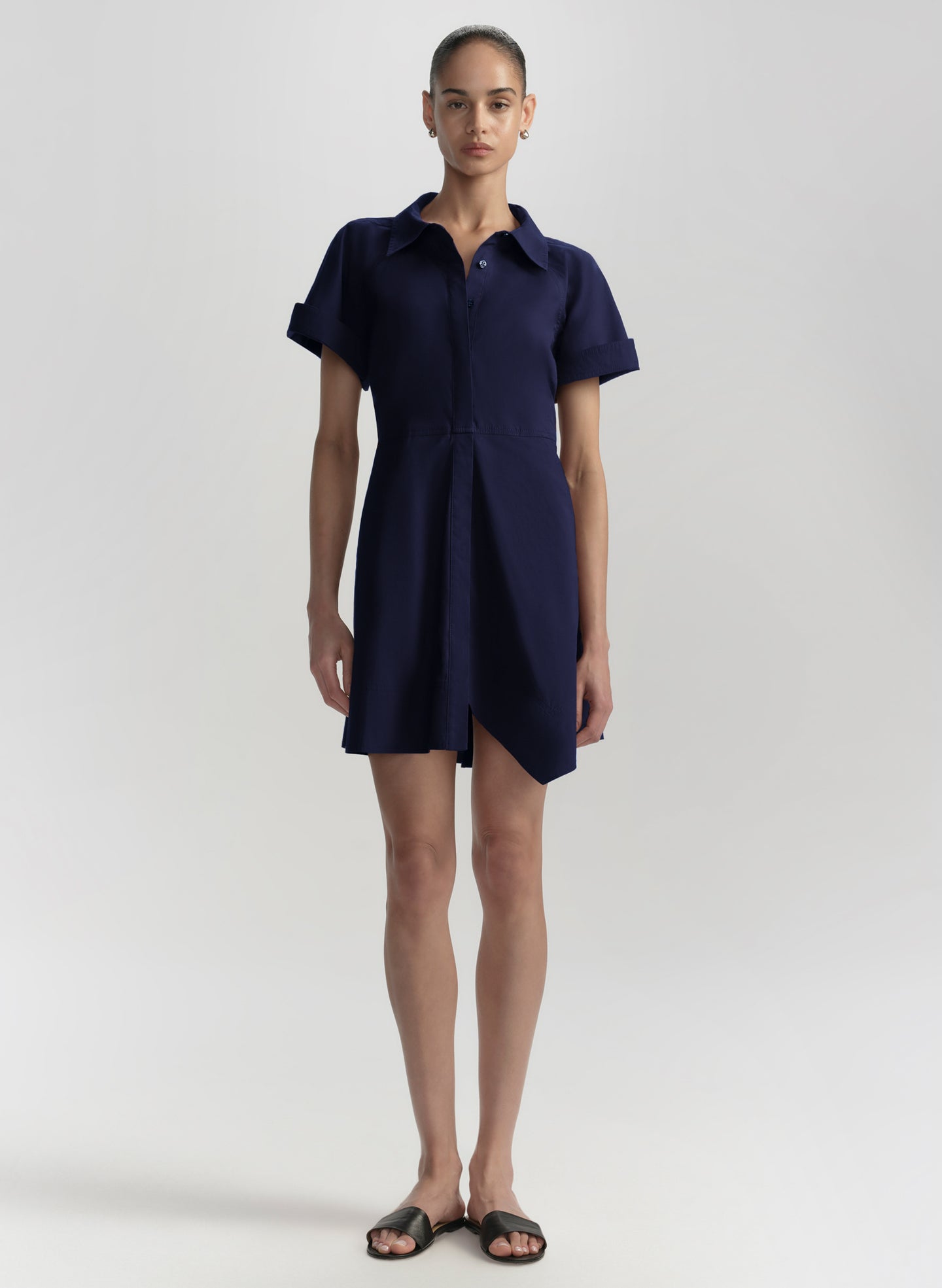 Woman wearing a navy blue dress on a white background