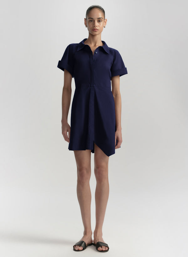 Woman wearing a navy blue dress on a white background