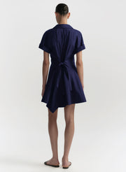Navy blue dress with a tie waist on a white background