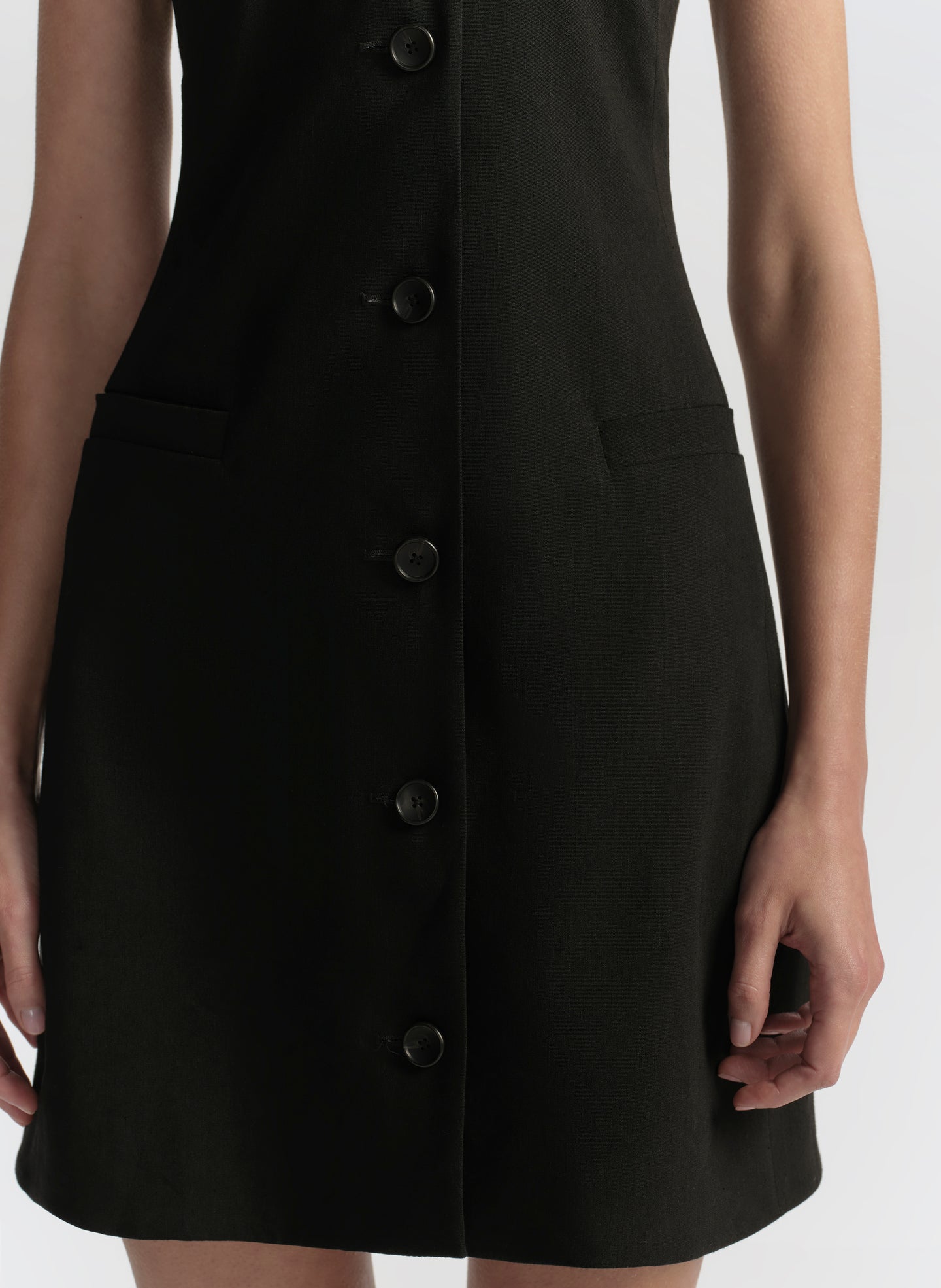 Black button-up dress on a white background