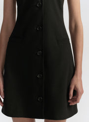 Black button-up dress on a white background