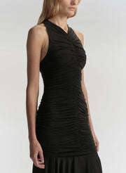 Woman wearing a black dress against a white background