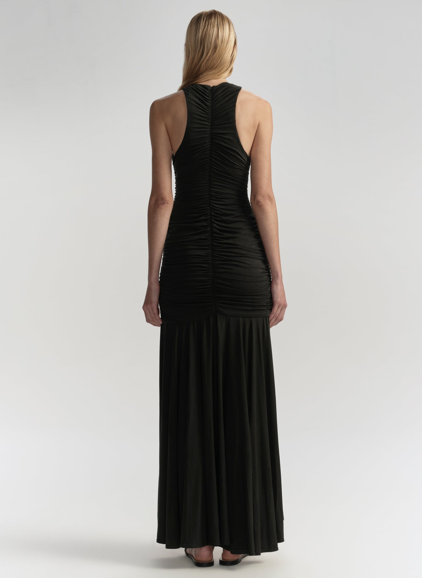 Black dress worn by a model on a white background
