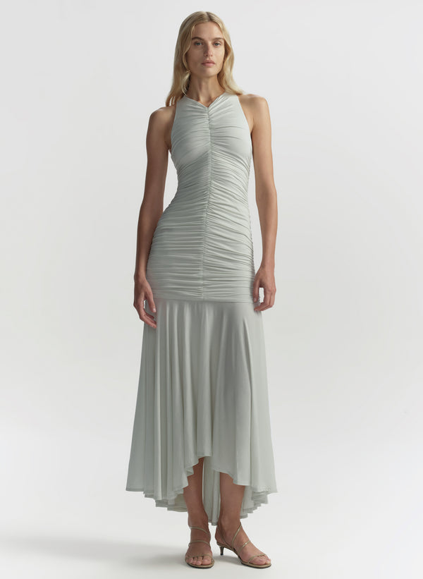 Woman wearing a light green dress on a white background