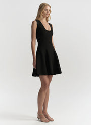 Woman wearing a black sleeveless dress on a white background