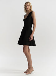 Woman wearing a black dress on a white background