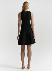 Black sleeveless dress worn by a model on a white background