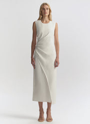 Woman wearing a white sleeveless dress on a white background