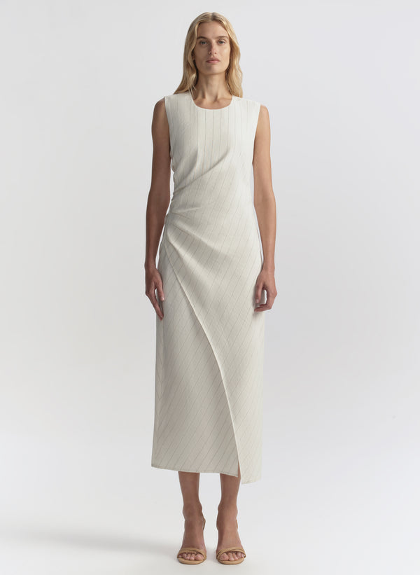 Woman wearing a white sleeveless dress on a white background