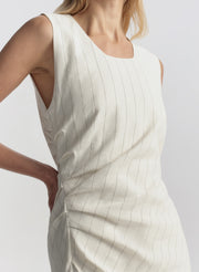 White sleeveless dress with a subtle pattern on a plain background