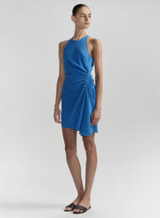 Woman wearing a blue dress on a plain background