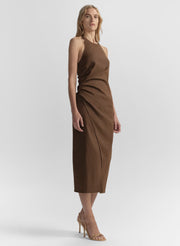 Woman wearing a brown dress against a white background