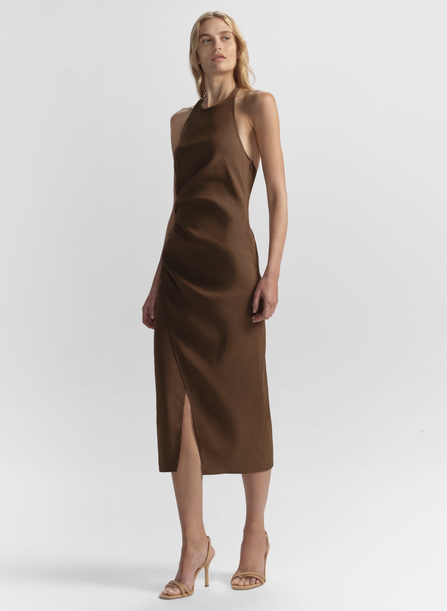 Woman wearing a brown dress on a white background