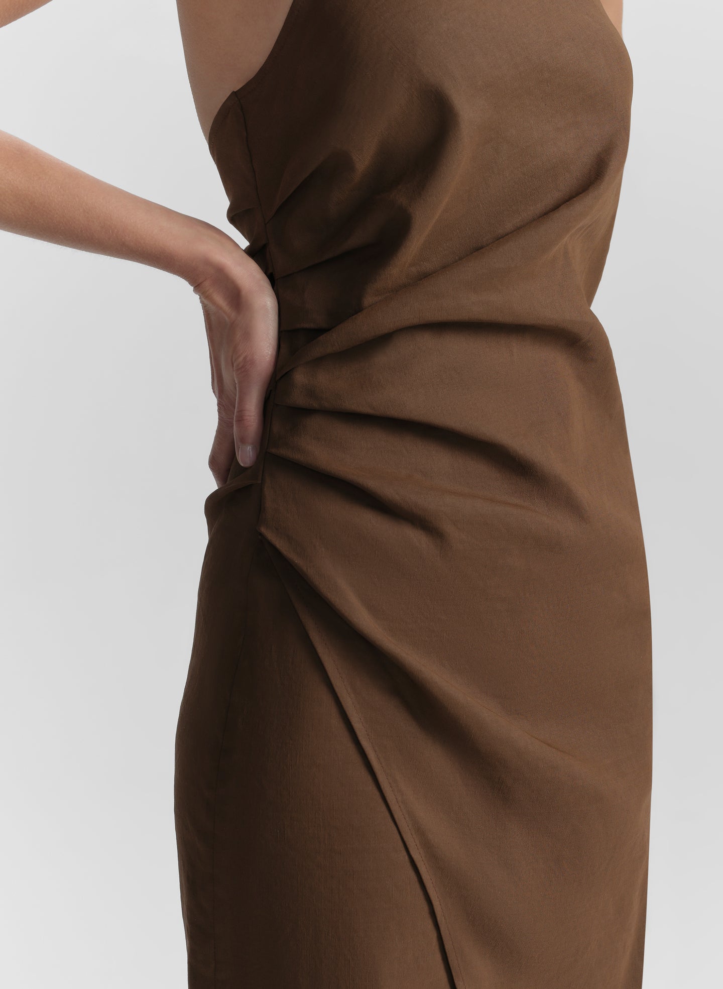 Brown dress with a ruching detail on a white background