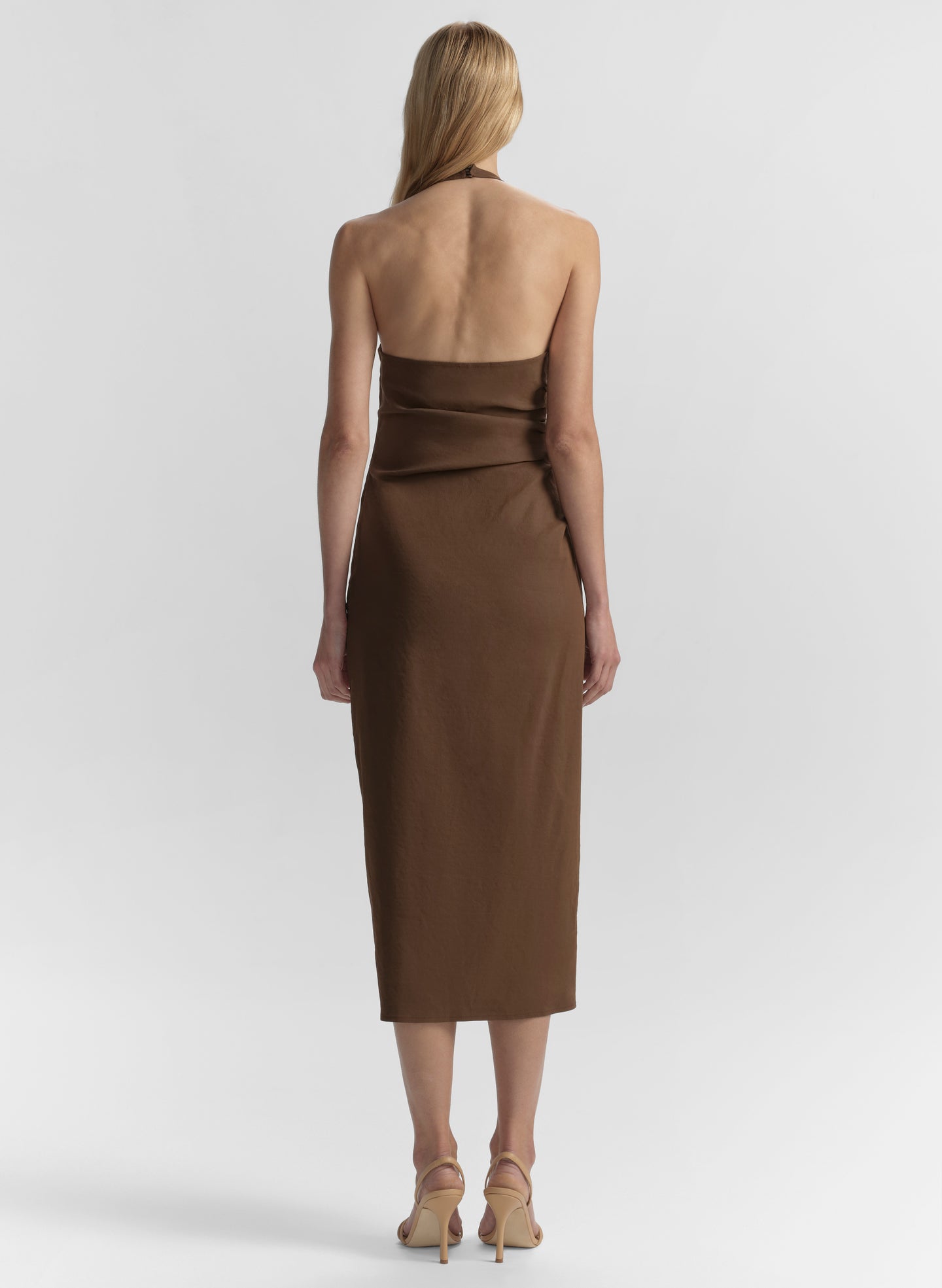 Woman wearing a brown dress on a white background